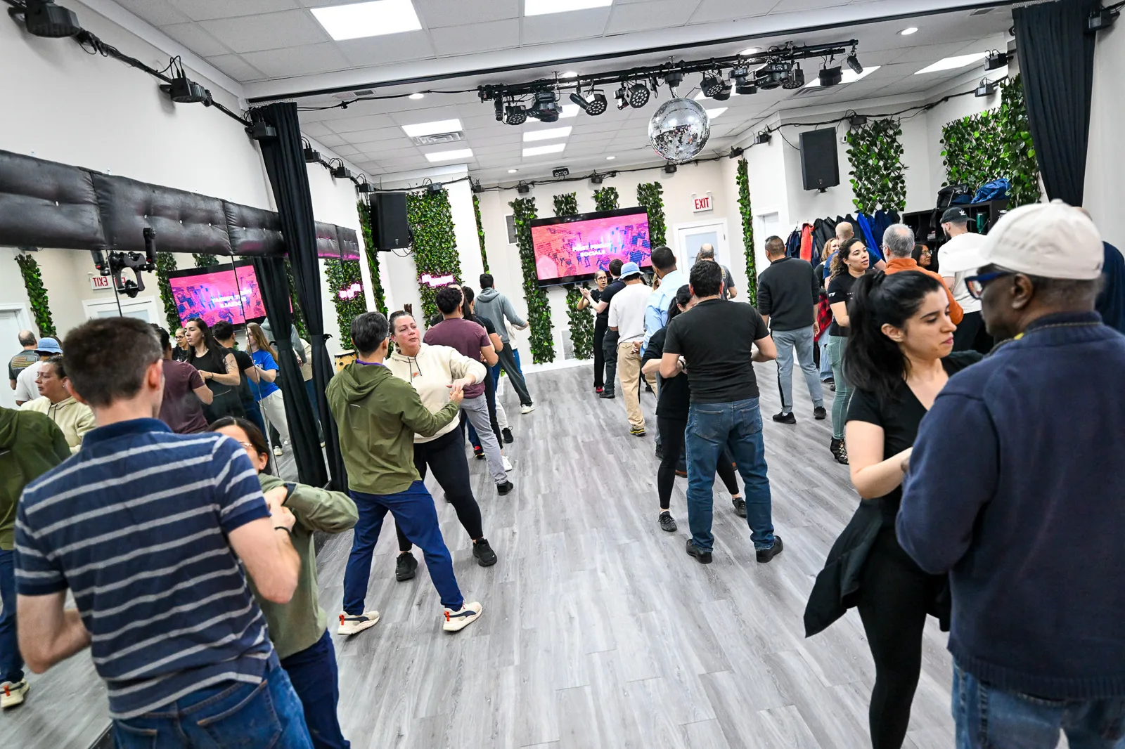 Beginner salsa and bachata group class practicing partner work at the Dennis PaSamba studio in Chicago