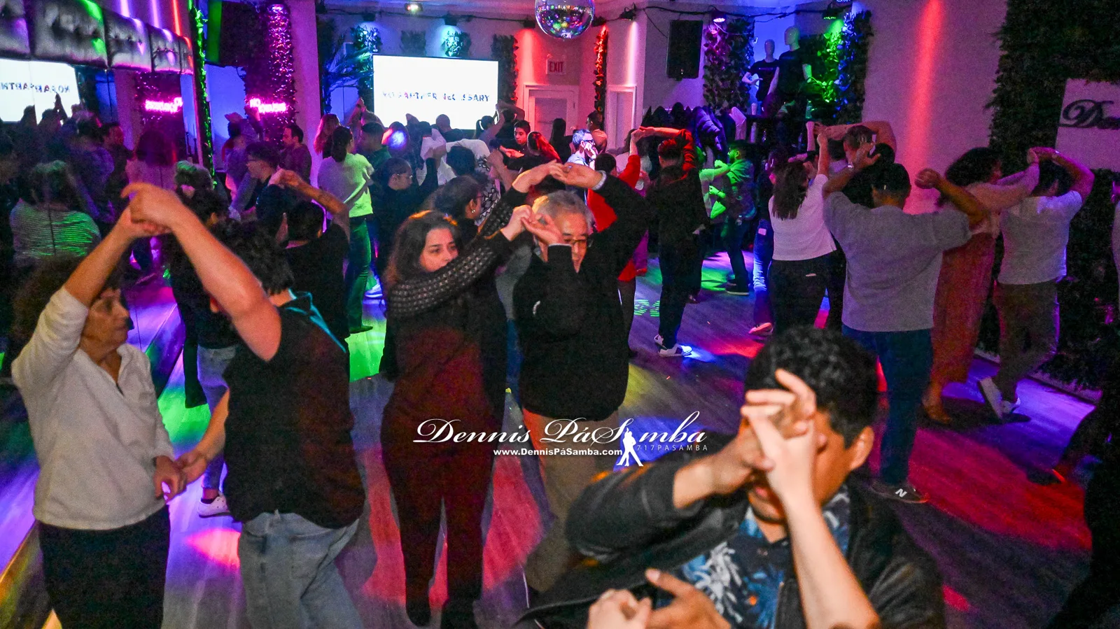 Couples dancing bachata in a beginner class at Dennis PaSamba Dance Company in Chicago
