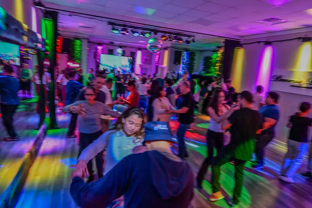 Students dancing salsa during a group class at Dennis PaSamba Dance Company in Chicago